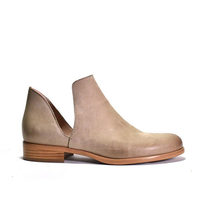 beige suede ankle boot with a stacked heel and a cut-out side