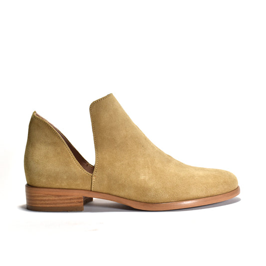 A tan suede ankle boot with a stacked heel and a open ankle on a white background