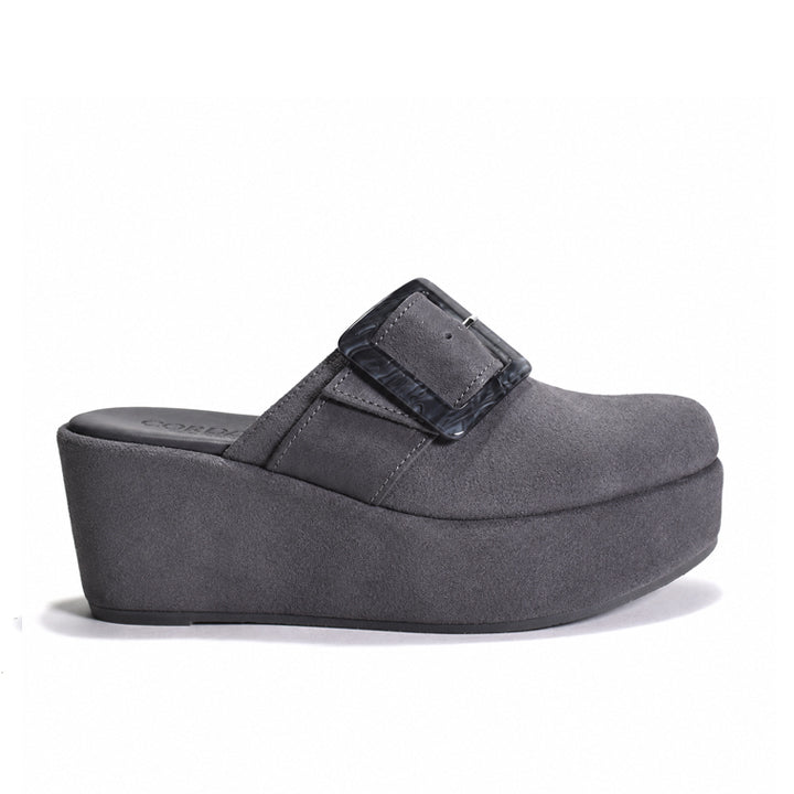 A dark gray wedge mule sandal with a wide strap and a glossy buckle, shown from a side profile on a white background.