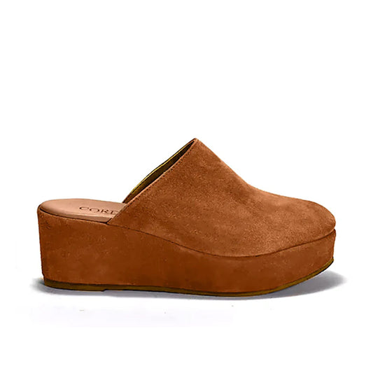 A brown suede clog with a platform sole and lightly padded leather footbed, set against a white background.
