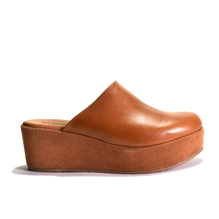 A single tan leather clog-style wedge shoe with a thick platform sole, shown in side profile against a plain white background.