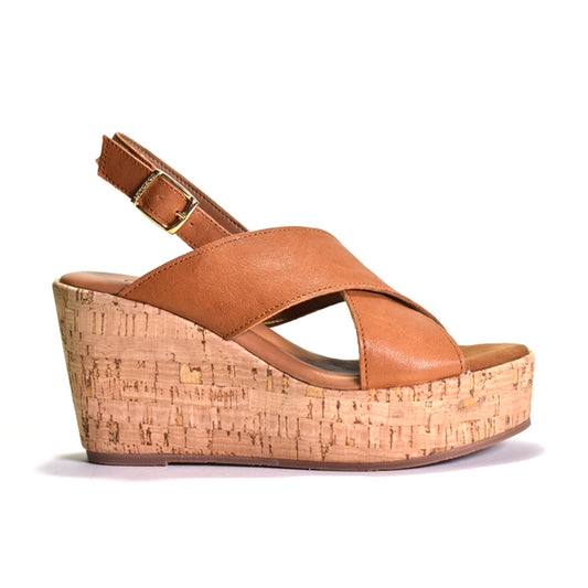 Brown wedge sandal with cork platform on a white background