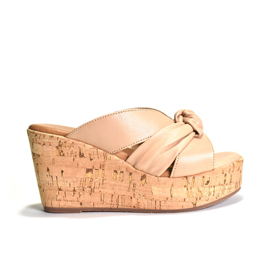 Beige wedge sandal with cork platform on a white background