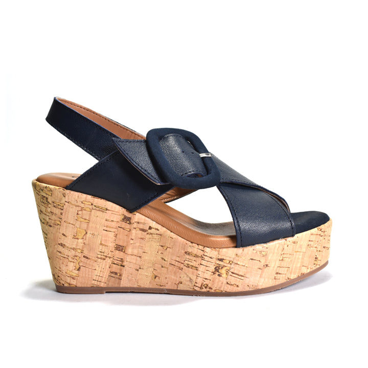 Navy wedge sandal with cork wedge sole on a white background