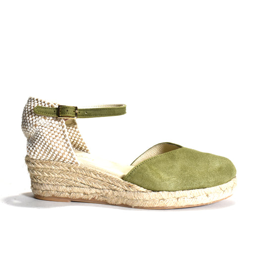 Green wedge sandal with woven sole on a white background