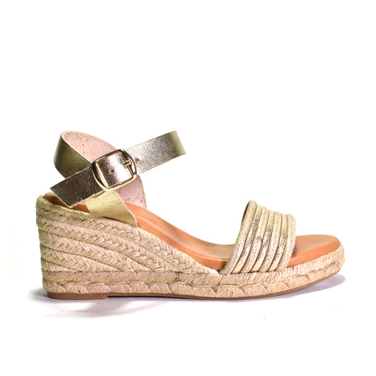 Gold wedge sandal with espadrille sole on a white background