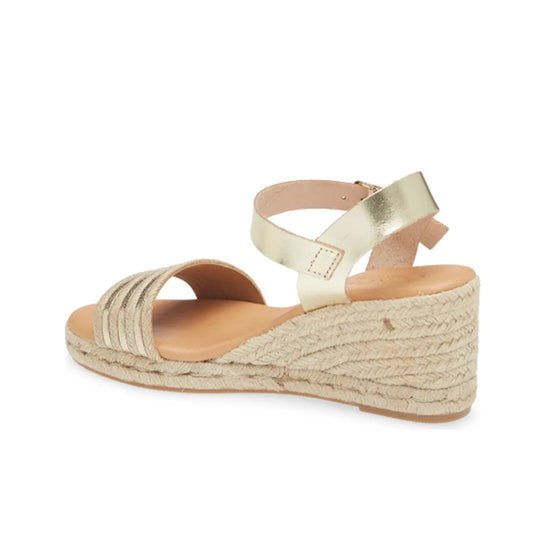 Gold wedge sandal with espadrille sole on a white background