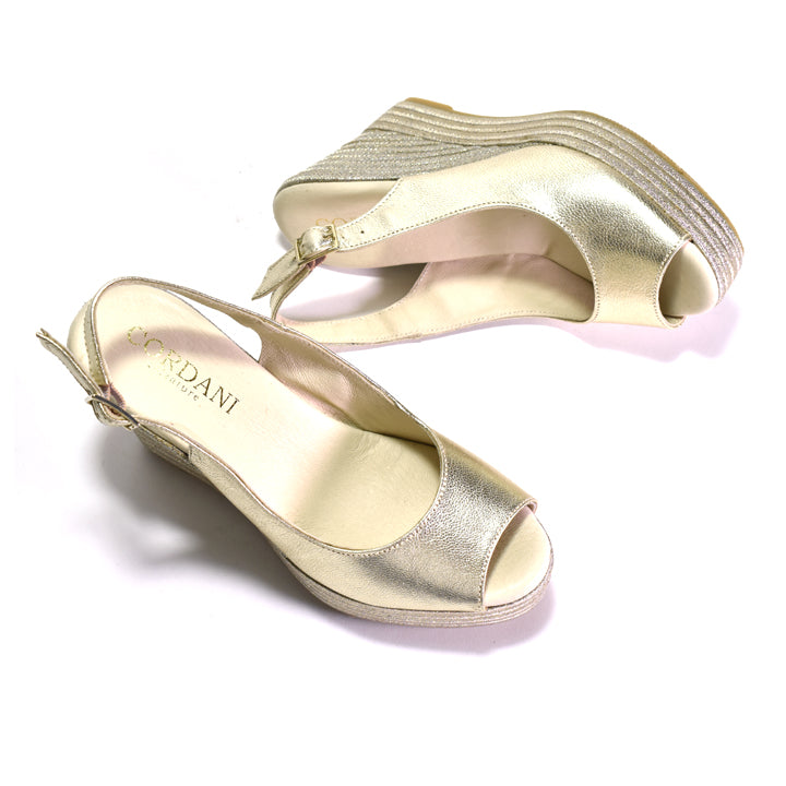Gold high-heeled shoes with 'CORDANI' branding on a white background
