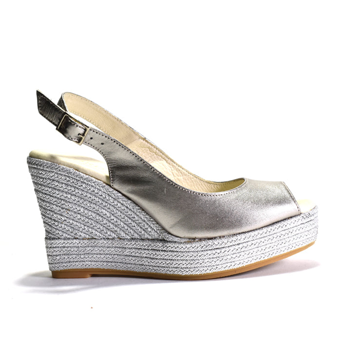 Silver wedge sandal with espadrille sole on a white background