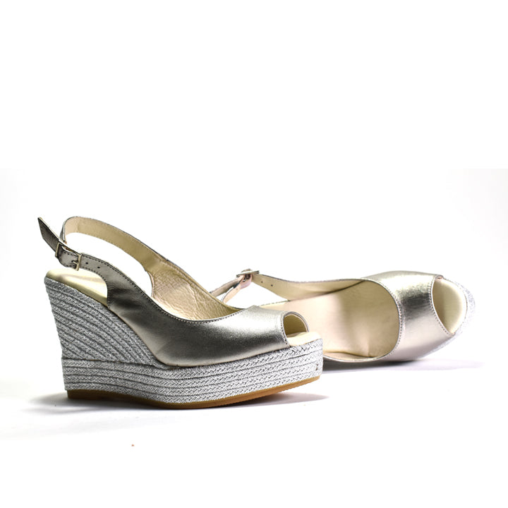 Silver wedge sandals on a white background