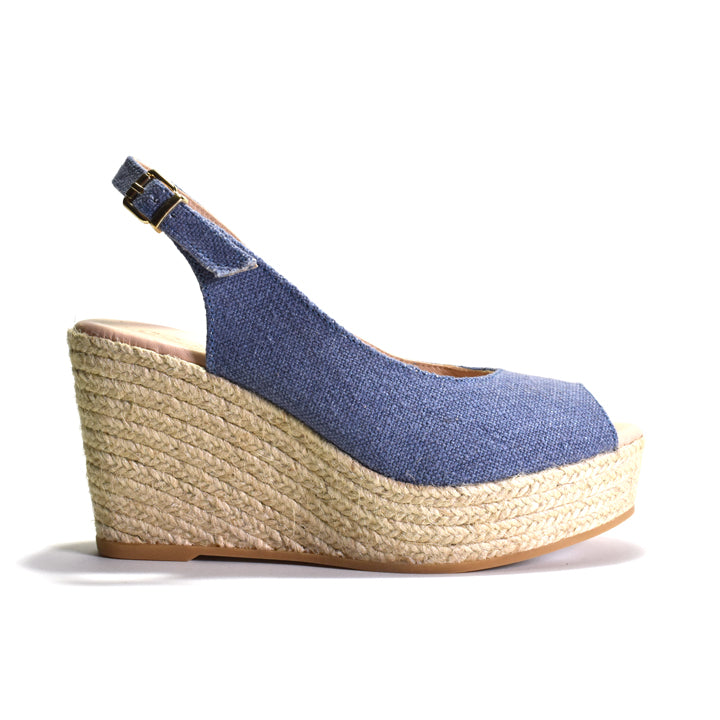 Blue wedge sandal with espadrille sole on a white background