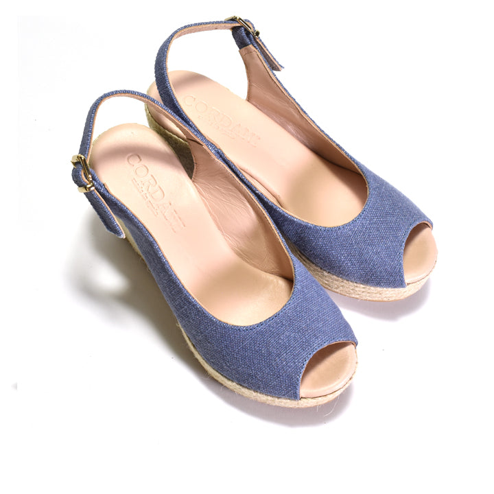 Pair of blue slingback sandals on a white background