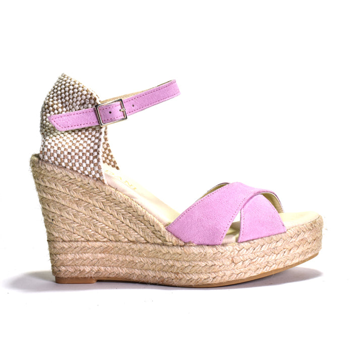 A pink espadrille sandal with adjustable ankle strap and a woven heel.