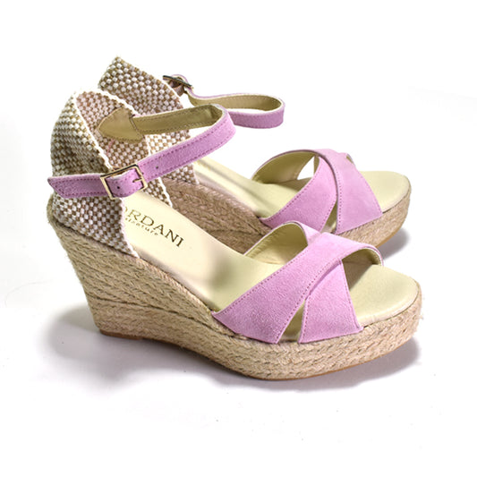 pair of pink espadrille sandal with adjustable ankle strap and a woven heel.