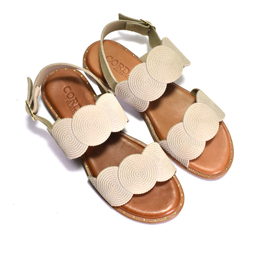 Pair of sandals with beige straps on a white background