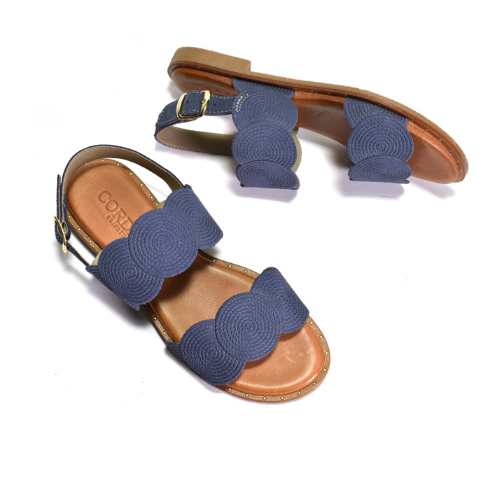 Pair of sandals with blue straps on a white background