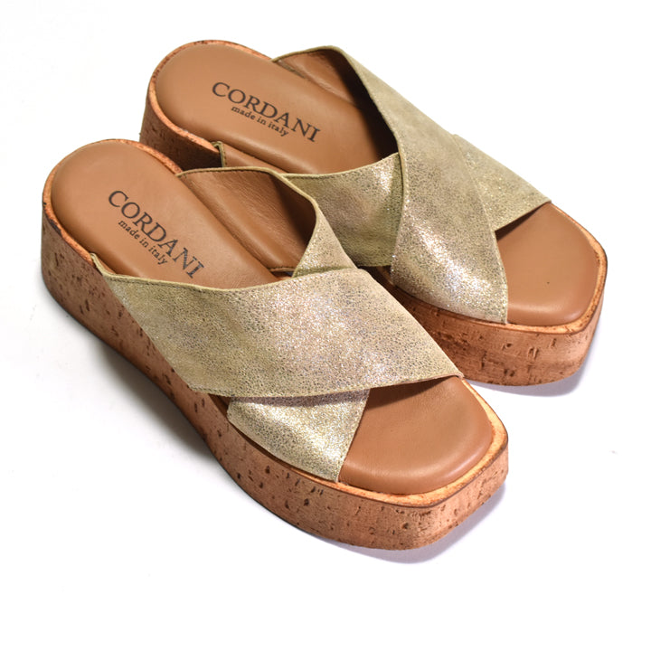 Gold sandals with cork sole and 'Cordani' branding on a white background