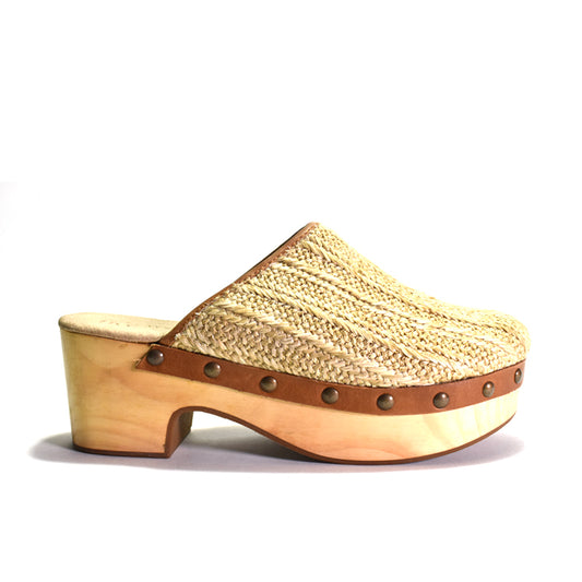 Wooden clog with woven top and brown leather trim on a white background