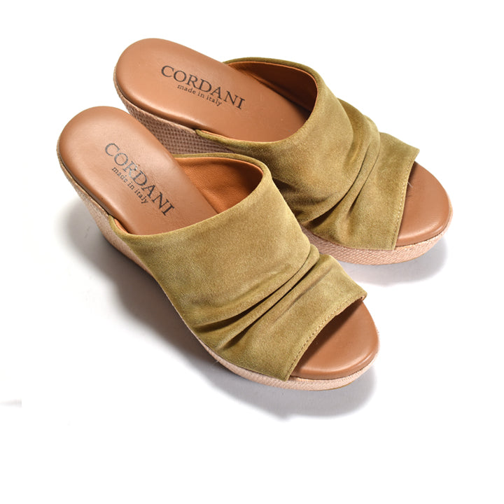 Green suede sandals with brown soles on a white background, featuring the Cordani brand.