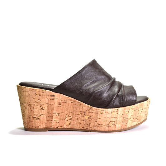 Dark brown wedge sandal with cork wedge sole on a white background