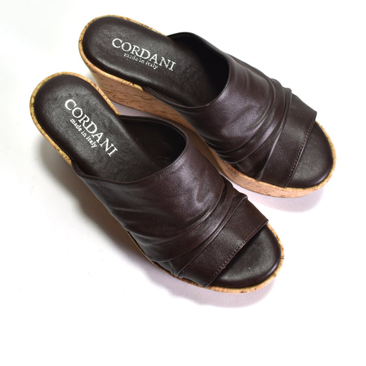Pair of brown sandals with 'Cordani' branding on a white background