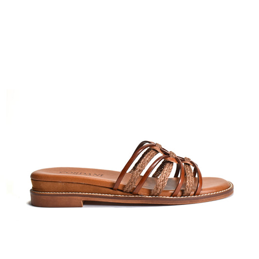 Brown sandal with woven design on a white background
