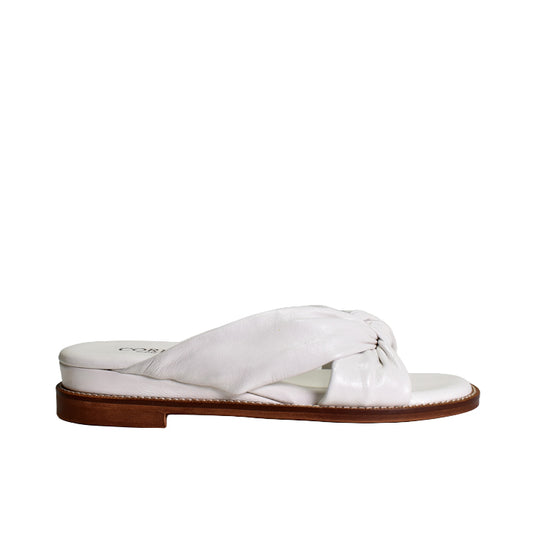White sandal with a brown sole on a white background