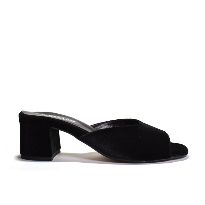 A black velvet mule sanda with a block heel on a white background.