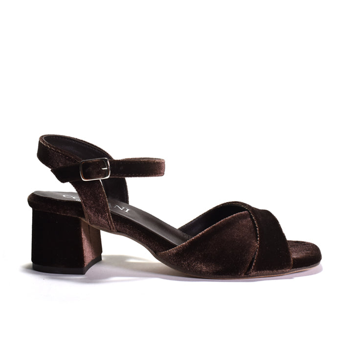 A single dark brown velvet block-heel sandal with an ankle strap and buckle, shown in a side profile on a white background.