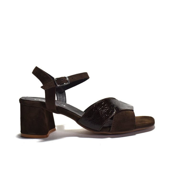 A single brown block-heel sandal with an ankle strap and buckle, featuring a textured patent leather toe strap, shown from a side profile on a white background.