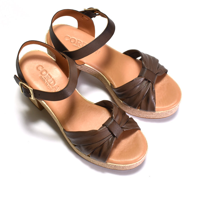Pair of brown sandals with a visible brand logo on a white background