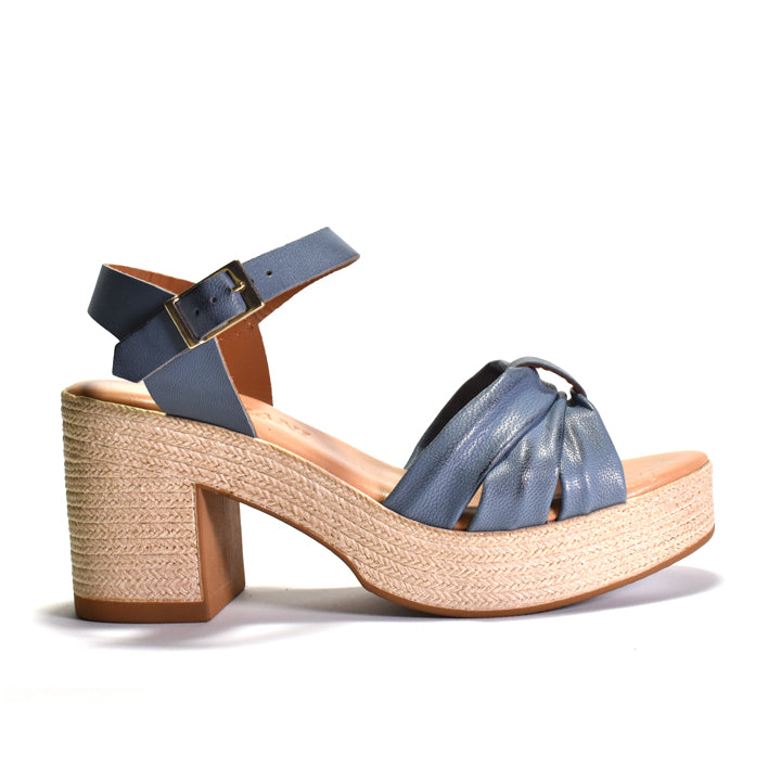 Blue sandal with woven look sole on a white background
