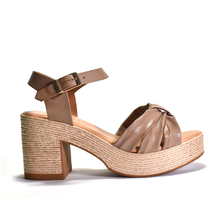 Beige sandal with woven look sole on a white background