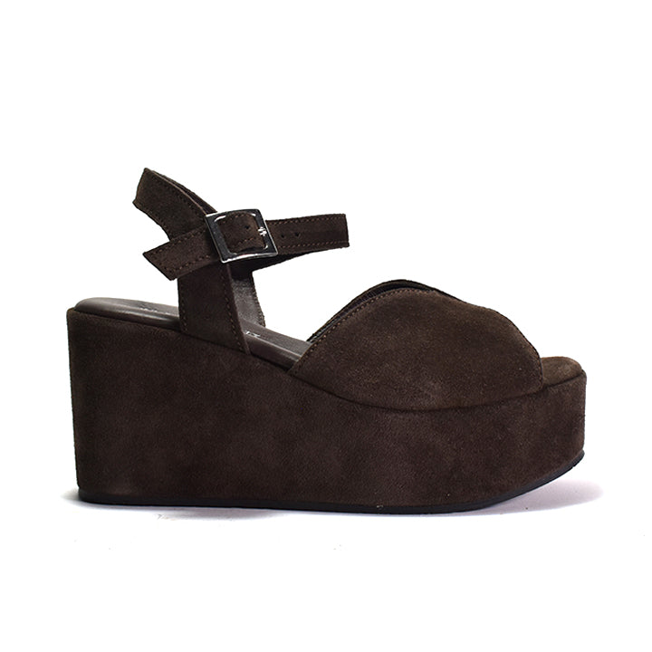 A dark brown suede platform sandal with an adjustable ankle strap and a wedge heel.