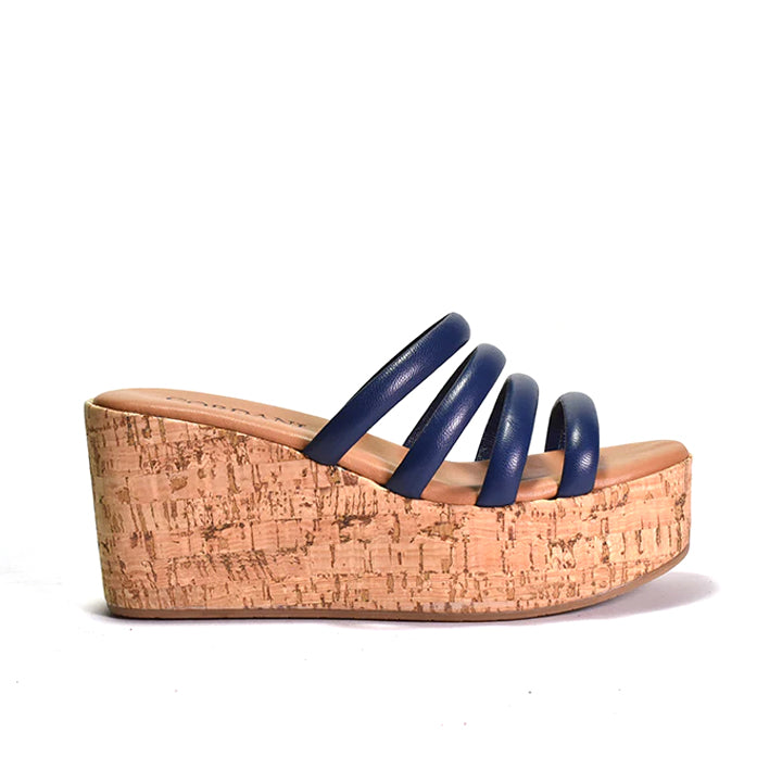Wedge sandal with cork sole and blue straps on a white background