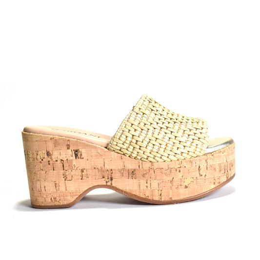 Woven sandal with cork wedge sole on a white background