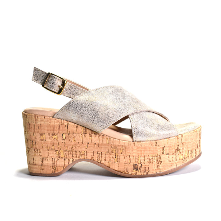 Gold wedge sandal with cork sole on a white background