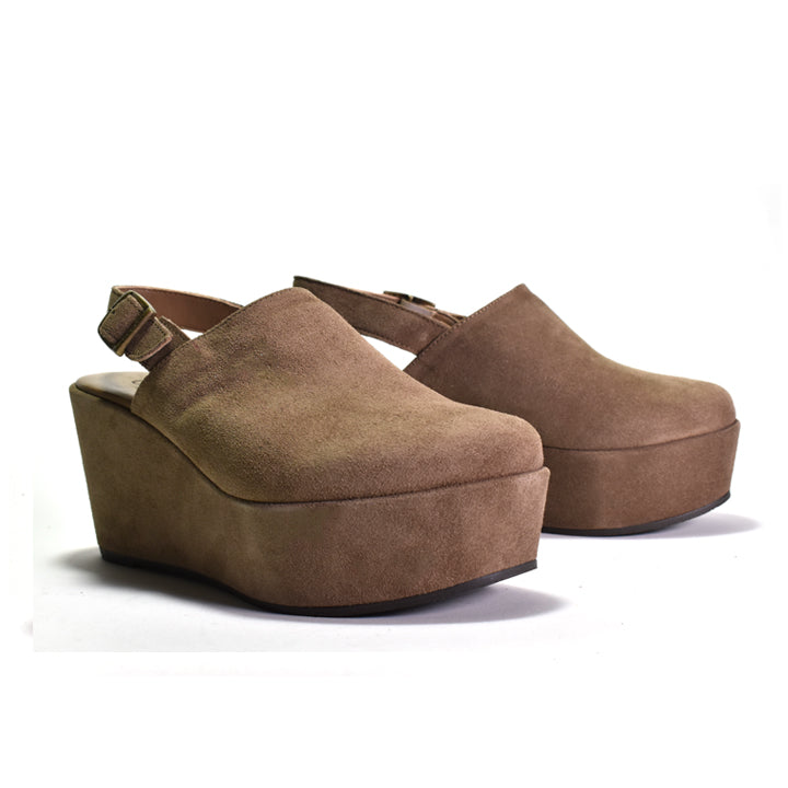 A pair of women's platform wedge clogs in a warm brown suede-like material, featuring slingback straps with small metal buckles, shown on a plain white background.