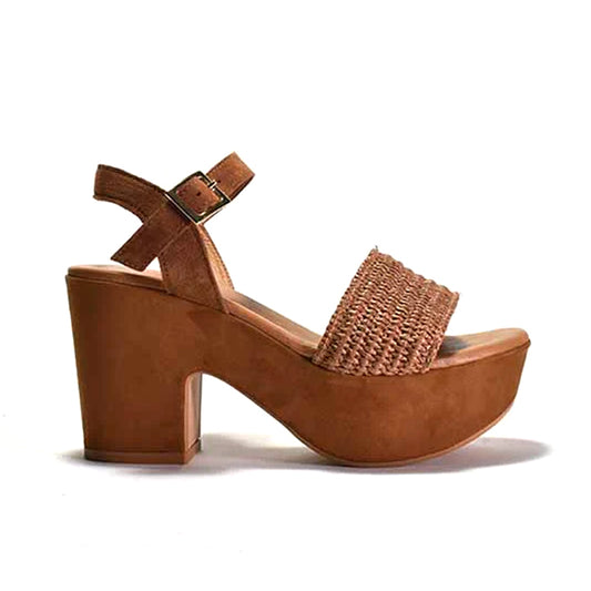 A brown platform sandal with a woven fabric and suede upper, featuring a suede wrapped heel and an adjustable metal buckle.