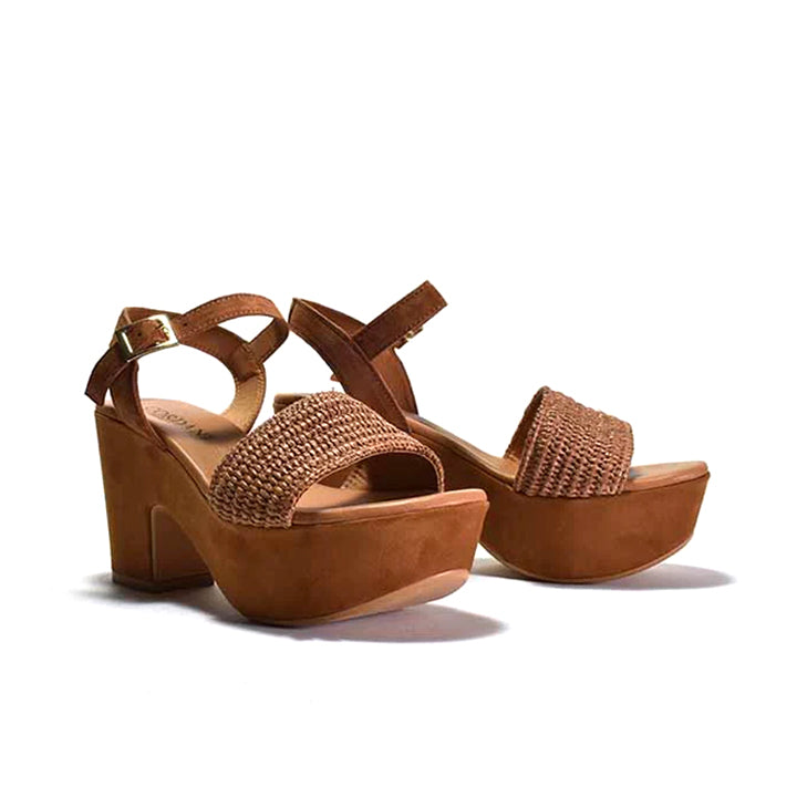 pair of brown platform sandals with a woven fabric and suede upper, featuring a suede wrapped heel and an adjustable metal buckle.