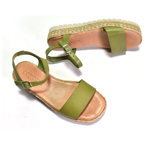 Pair of green sandals with woven sole on a white background