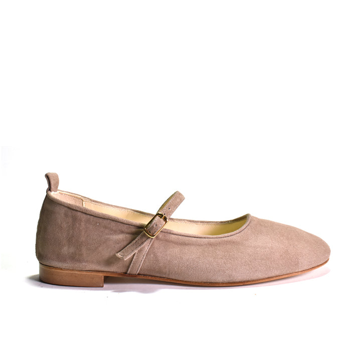 Beige flat shoe on a light gray background