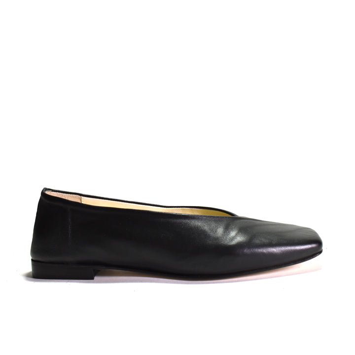 Black flat shoe with low heel on a white background