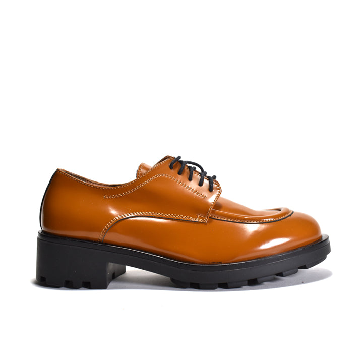 Brown leather shoe with black sole on a white background