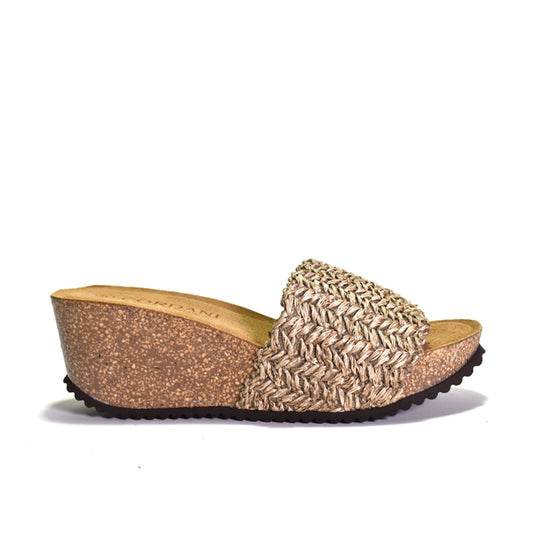 Woven sandal with cork wedge sole on a white background