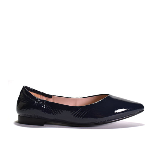 Navy patent leather flat shoe on a white background