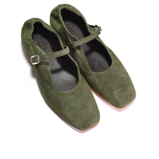 A pair of olive green suede Mary Jane flats with square toes and silver buckle straps, shown on a white background.