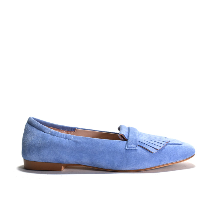 Blue suede loafer with tassel on a white background