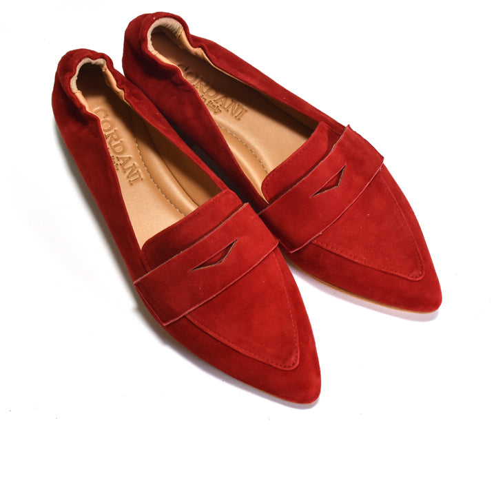 A pair of red suede pointed-toe loafers with a decorative cutout detail across the vamp, displayed on a clean white background. The tan insoles show the brand name 'JORDAN'.
