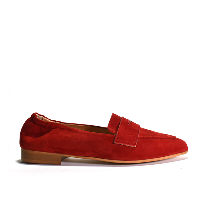 A single red suede penny loafer shown in profile against a clean white background.